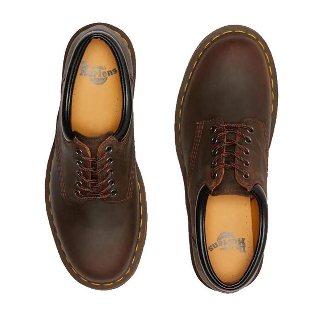 A pair of Dr Martens 8053 Crazy Horse Dark Brown Leather 5 Eye shoes with yellow stitching and air-cushioned soles seen from above. The left shoe has plain brown laces; the right has brown and red striped laces., 52072, 52073, 800090801651, 800090801675, 