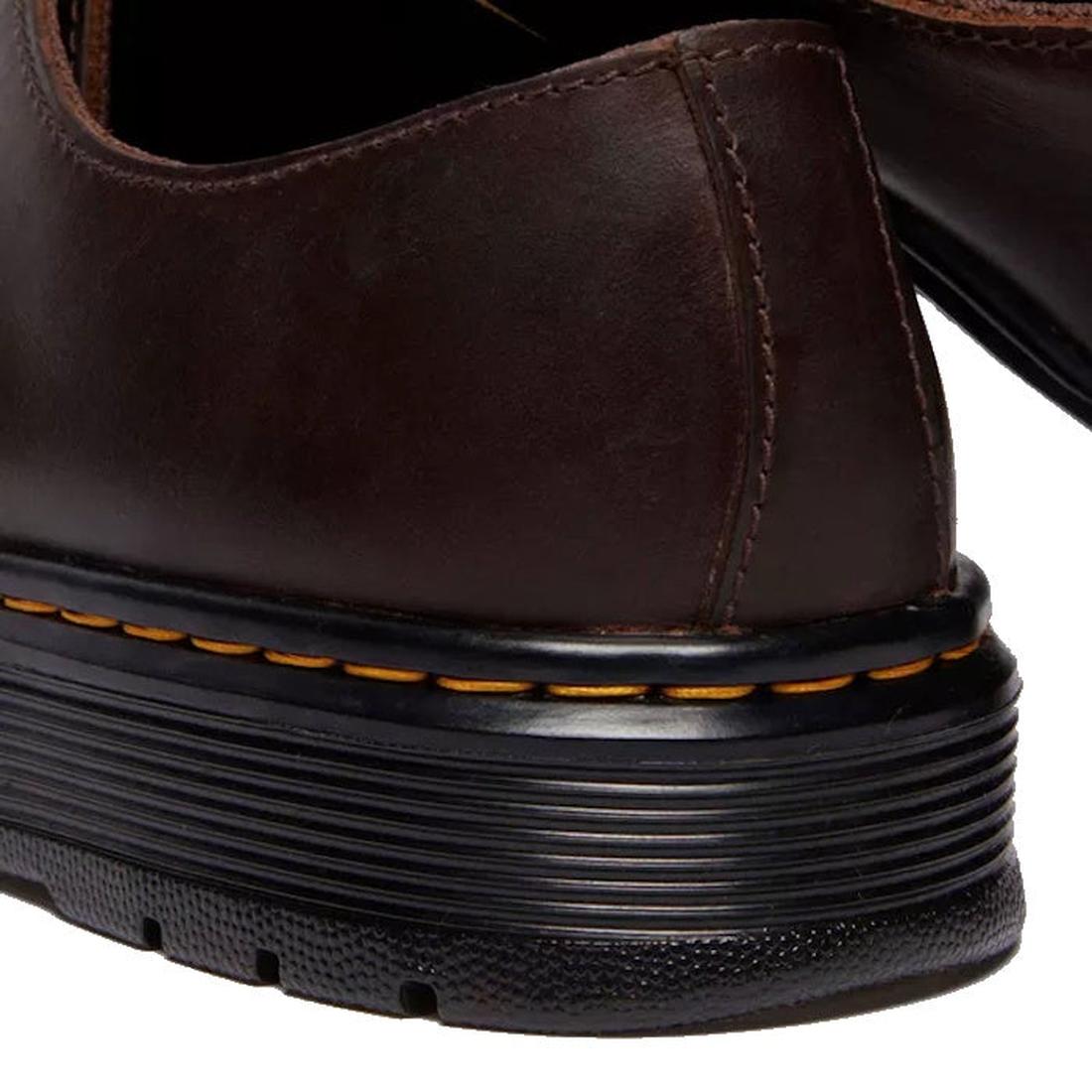 Close-up of the heel of a Dr Martens Brookline Lo Dark Brown Crazy Horse Leather Shoe, highlighting visible stitching and a black rubber sole with yellow stitching detail., 52062, 52063, 52064, 190665753912, 190665753936, 190665753943, 190665753950, 52069