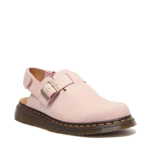 A powder pink Dr. Martens Jorge II mule sandal with an adjustable buckle over teh top of the foot , Ripstop ankle strap, and a grooved Shore sole with yellow stitching around the sole.