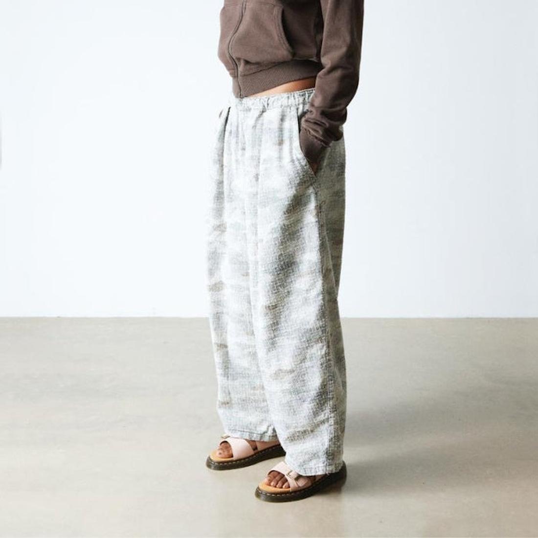 Person wearing white patterned pants and a brown top and Dr Martens Pink Josef slide sandals on a plain background,
190665707533,
190665707540,
190665707557,
190665707571,
190665707588,, 190665707533, 190665707540, 190665707557, 190665707571, 190665707588
