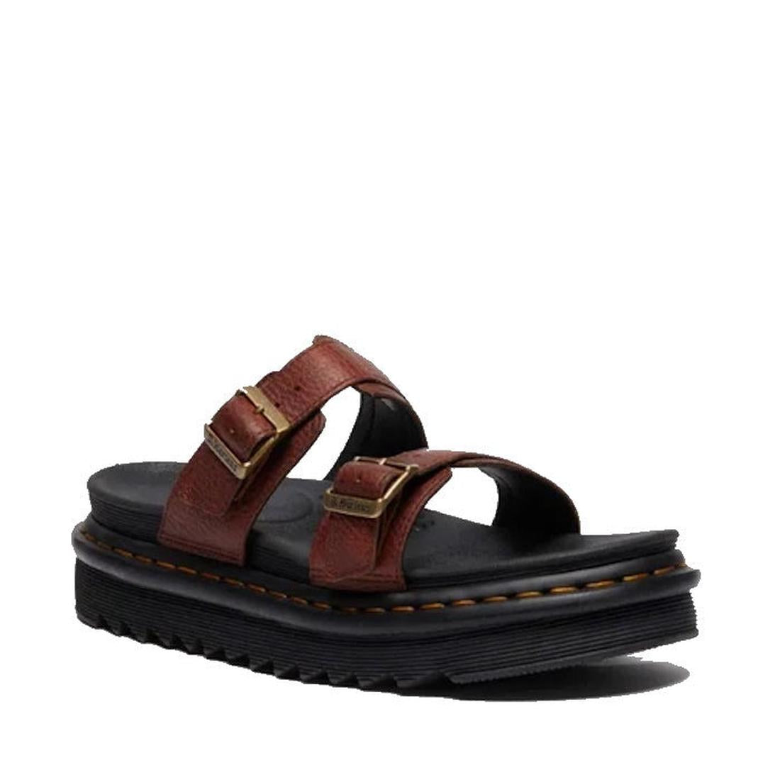 A Dr Martens Myles Cashew Ambassador Brown Leather Sandal with two adjustable buckle straps and a thick black EVA Zebrilus sole with yellow stitching, displayed at an angle to show both the side and top.