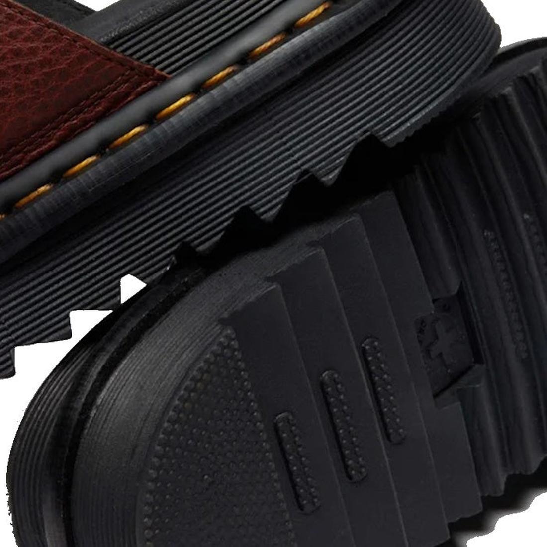 Close-up of a Dr. Martens Myles Cashew Ambassador Brown Leather Sandal, featuring thick rugged EVA Zebrilus soles, yellow stitching, and a brown leather strap., 49260, 190665772081, 190665772098, 190665772104, 190665772128, 190665772135, 190665772142, 190
