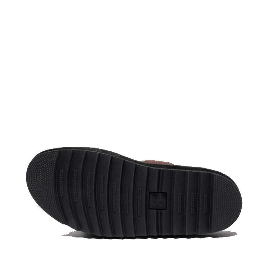 A close-up of the black EVA Zebrilus sole on the Dr Martens Myles Cashew Ambassador Brown Leather Sandal displays horizontal traction grooves and a small square logo in the center, set against a white background., 49260, 190665772081, 190665772098, 190665