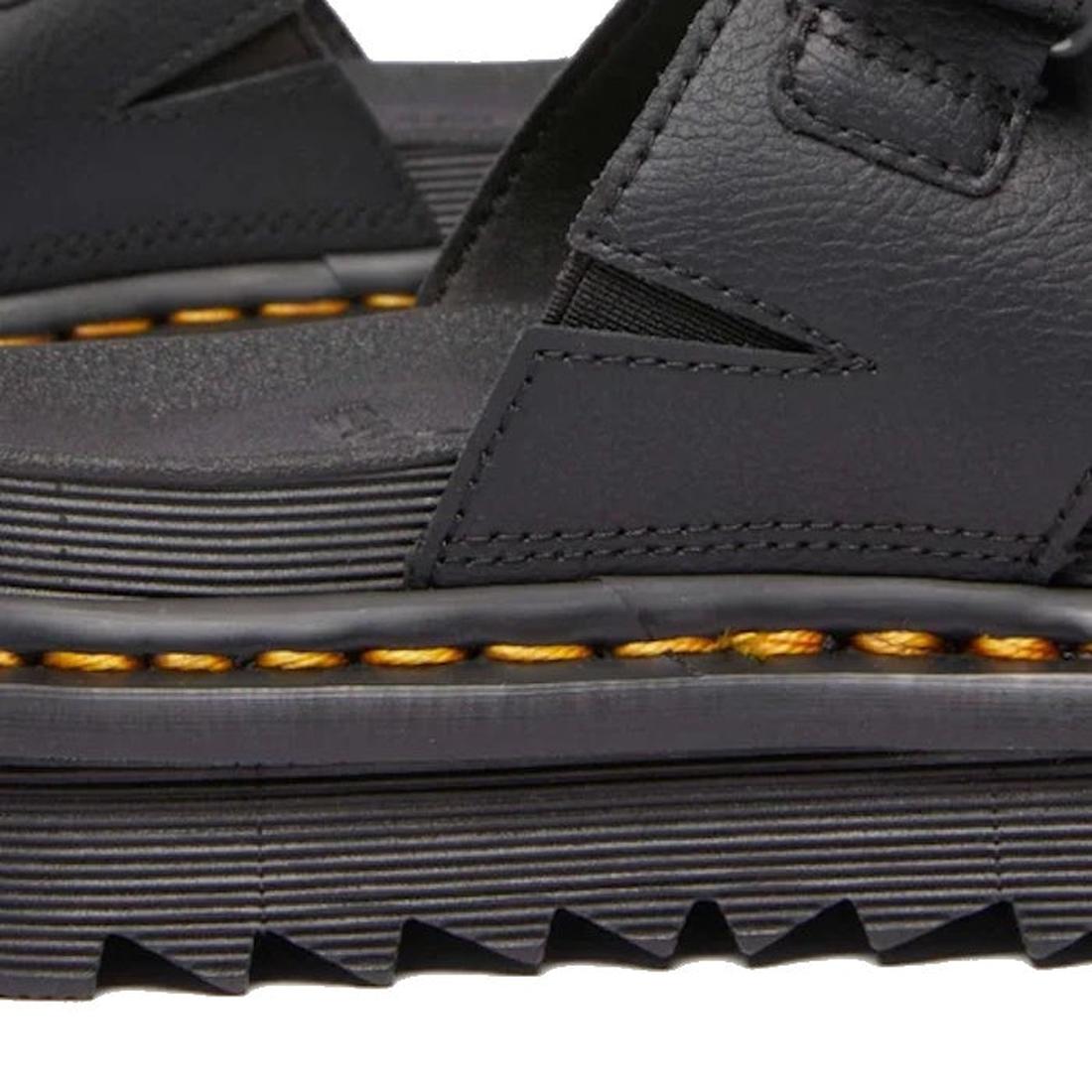 Close-up of a Raine Dr Martens black leather sandal with a textured sole on a white background showing the classic yellow stitching around the base.,
190665717761,
190665717778,
190665717785,
190665717808,
190665717815,
190665717822,, 41936, 190665717761,
