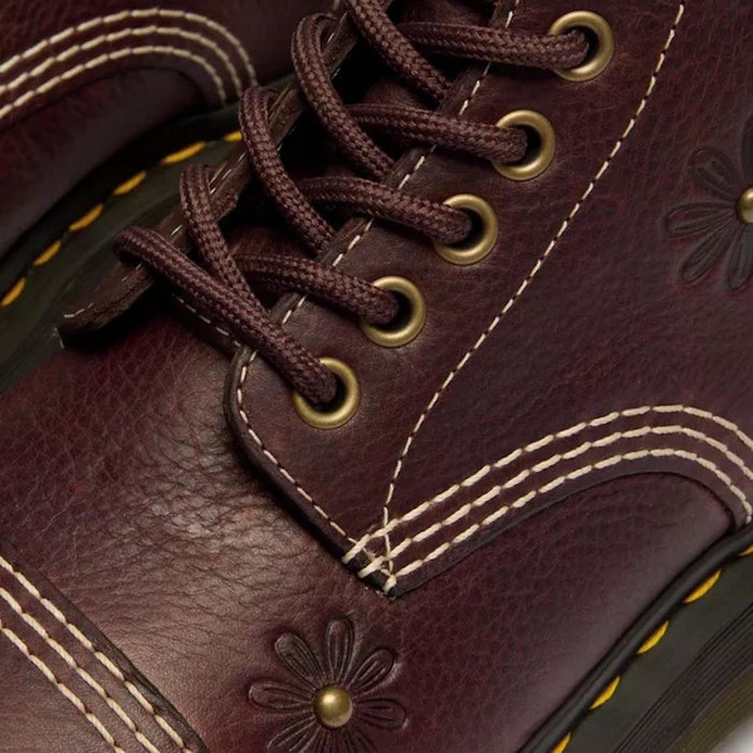 Close-up of Dr Martens Sinclair Flower Dark Brown Grizzly Leather Boot featuring brown laces, brass eyelets, white decorative stitching, embossed floral patterns, and yellow stitching on the platform Quad sole., 51903, 51904, 190665777116, 190665777123, 1