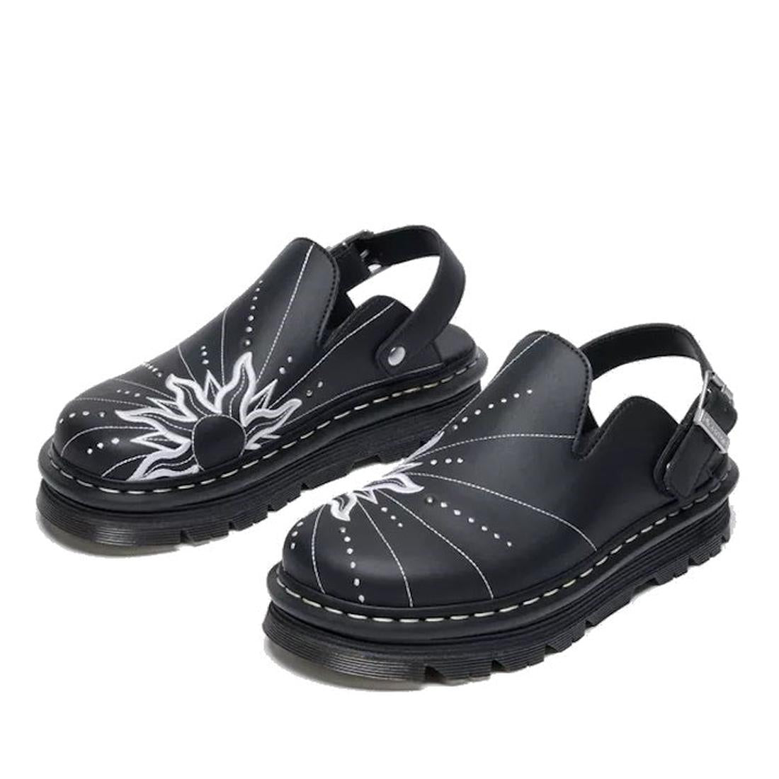 The Dr Martens Zebzag Mule Solar Flare Genix Nappa Black features black slingback clogs with an ergonomic sole, white stitching, and a bold sunburst front design., 190665758818, 190665758825, 190665758832, 190665758856, 190665758863, 190665758870, 1906657