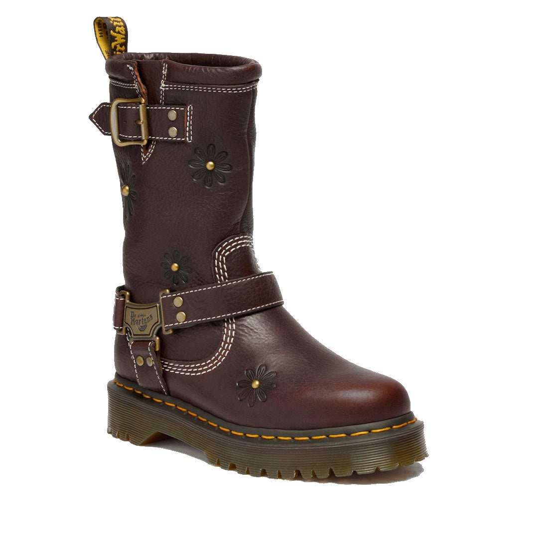 The Dr Martens Anistone Hi Flower Bex Grizzly Dark Brown is a mid-calf biker-style boot in brown leather, featuring floral embossing, two buckled straps, yellow stitching on a chunky treaded sole, and bold floral details.