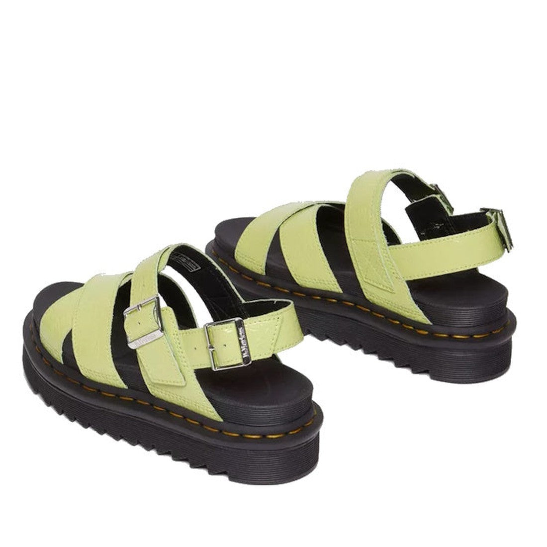 A pair of Dr Martens Voss II Cross Strap Sandal in distressed patent lime green, featuring metallic buckles and thick black soles with yellow Goodyear welt stitching, are angled on a white background., 41508, 41509, 190665646665, 190665646672, 19066564669