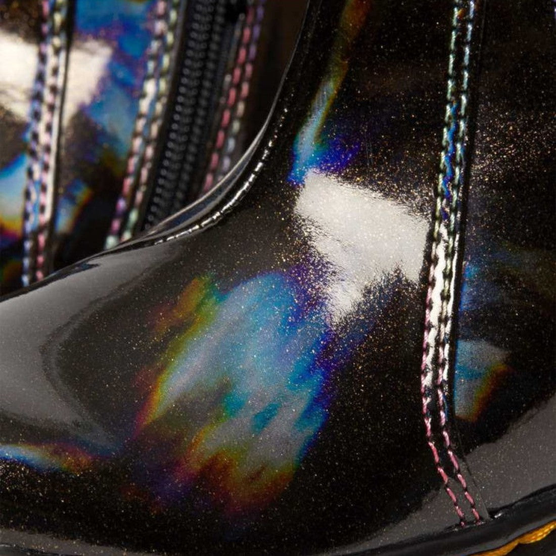 Close-up of the Dr Martens Kids Toddlers 2976 T Chelsea Boot in Black Lightshow Sparkle Rays, featuring glossy iridescent material with colorful reflections, pink stitching, zip detail, and glitter side gussets. LAST ONE toddlers UK8., 190665494914, 19066