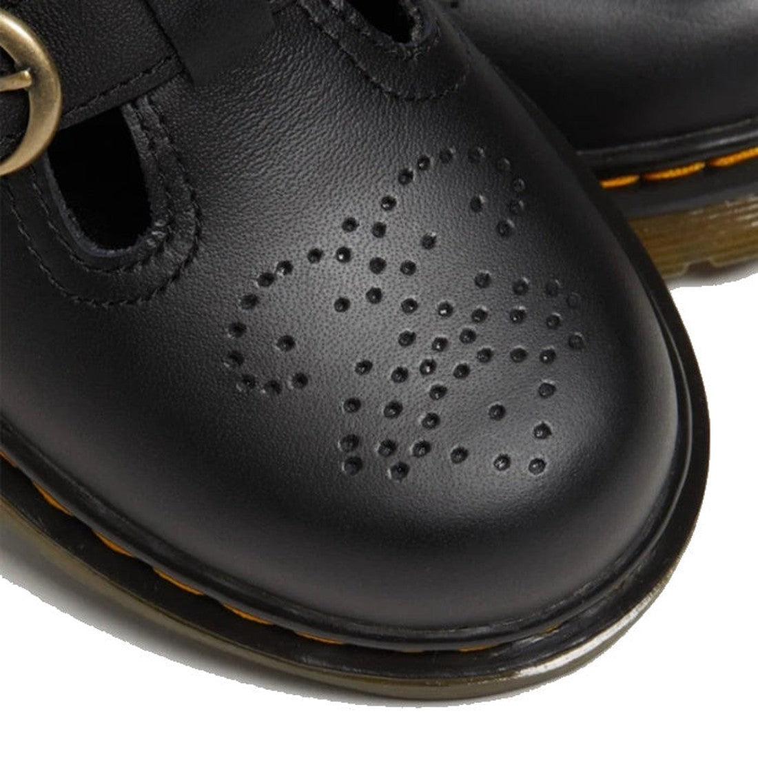 Close-up of the Dr Martens Kids 8065 J Black Softy T Mary Jane Leather Shoe, crafted from soft leather with a perforated heart design on the toe, signature yellow stitching, and an air-cushioned sole for comfort., 41982, 41983, 190665537093, 190665537109,
