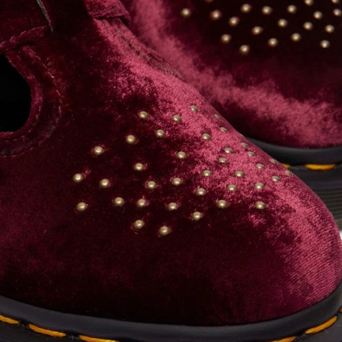 Close-up of Dr Martens 8065 2 Strap Mary Jane Vegan Cherry Red Velvet shoes, featuring gold studs on the toe and yellow stitching along the edge of the black sole., 42014, 190665660548, 190665660555, 190665660579, 42018, 42019