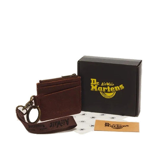 Dr. Martens Cardholder Keyring Cashew Ambassador Leather Bag Charm featuring a key ring, wrist strap, and cardholder section, displayed next to a black Dr. Martens box, a branded card, and branded tissue paper.