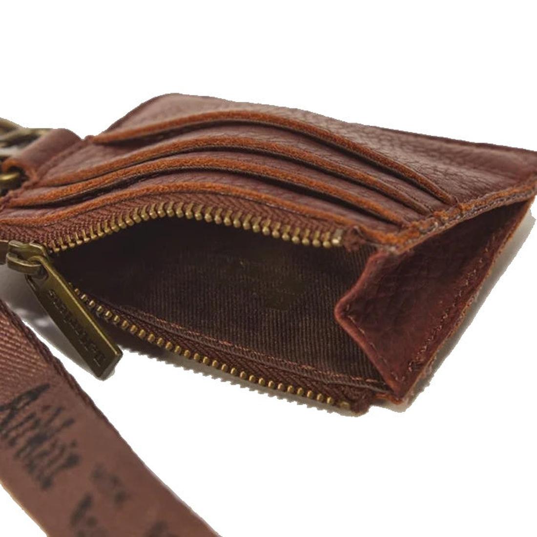 Dr Martens Cardholder Keyring Cashew Ambassador Leather Bag Charm shown open on a white background—this versatile accessory, crafted from brown leather, features a brass zipper, several card slots, a fabric-lined interior, and a detachable wrist strap for