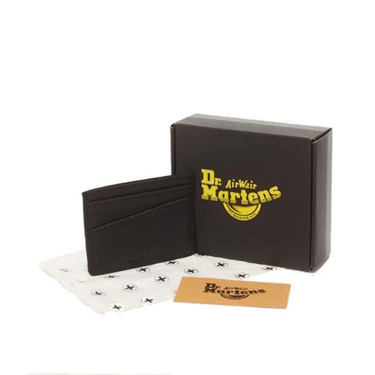 The Dr Martens Cardholder II Black Ambassador Leather Wallet is showcased beside its branded box, a logo-printed paper wrap, and a brown card, all set against a white background.