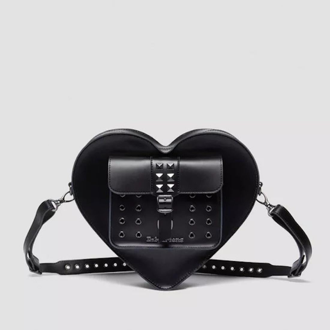 Dr Martens Heart Shaped Bag Hardware Kiev Leather is a charming black crossbody with sturdy sole, secure flap, and shiny metal studs.  ksnz