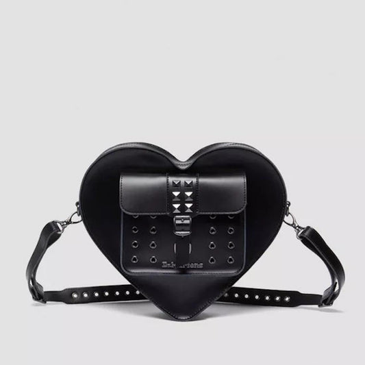 Dr Martens Heart Shaped Bag Hardware Kiev Leather is a charming black crossbody with sturdy sole, secure flap, and shiny metal studs.  ksnz