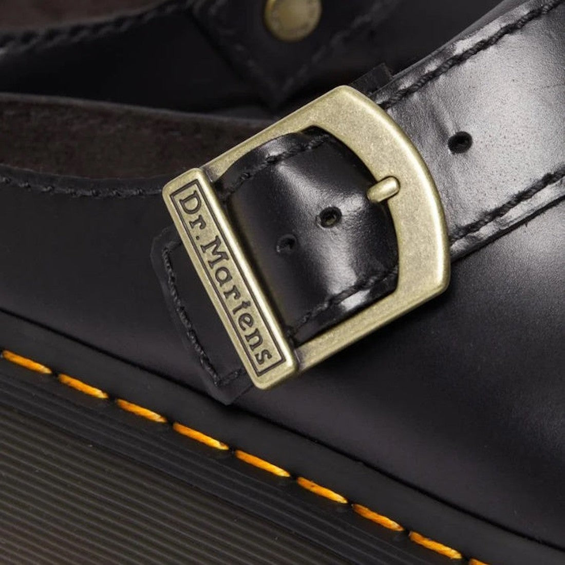 Close-up of the Dr Martens Laketen Black Atlas Archive Mule Slide Sandal, featuring a chunky platform, engraved brass buckle, and signature yellow stitching around the sole., 190665644302, 190665644319, 190665644333, 190665644340, 190665644357