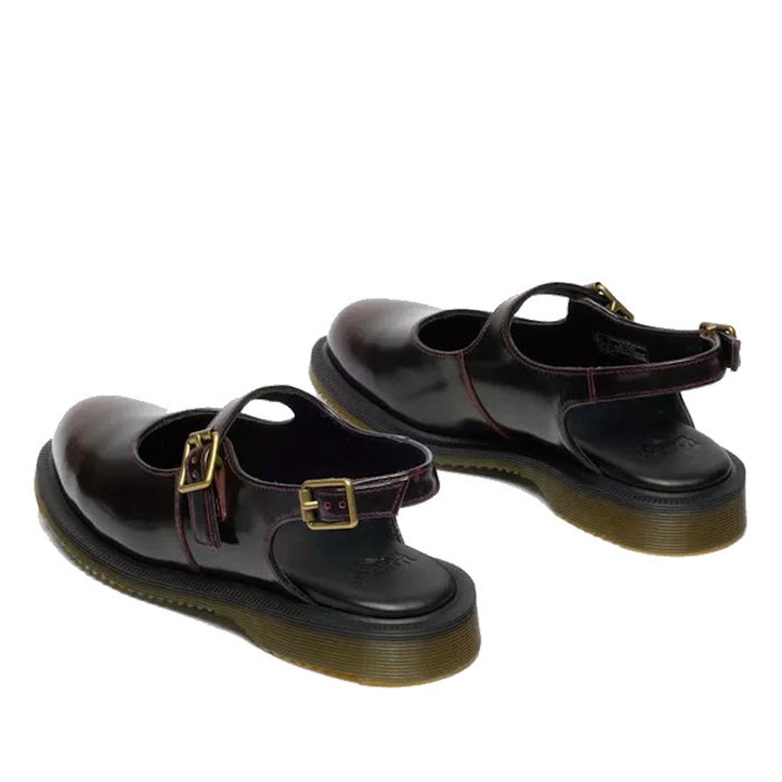 A pair of Dr Martens Madaline Cherry Red Arcadia Women’s Slingback Mary Jane Shoes with chunky black Goodyear Welted soles, gold buckle straps, and polished leather are displayed facing away on a white background.