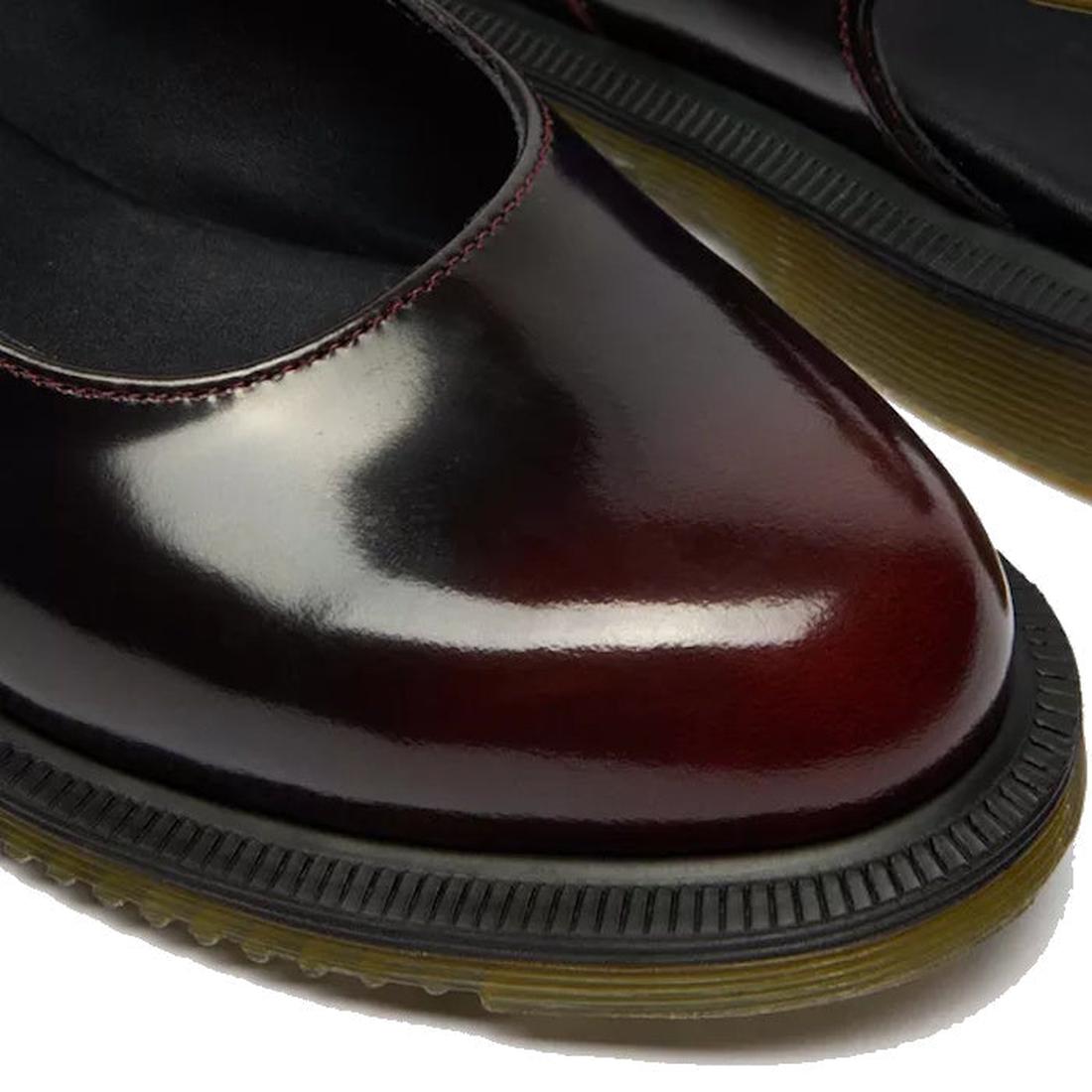 Close-up of Dr Martens Madaline Cherry Red Arcadia Women's Slingback Mary Jane Shoes with polished smooth leather, rounded toes, black cushioned insoles, contrasting stitching, and thick black soles with yellow-brown Goodyear welted edges.