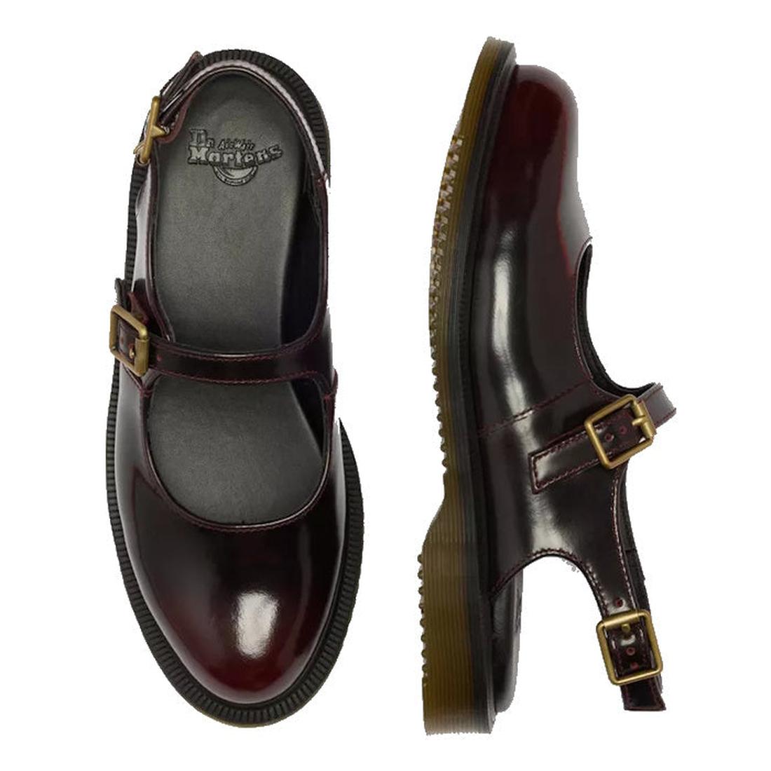 A pair of Dr Martens Madaline Cherry Red Arcadia Womens Slingback Mary Jane Shoes in polished leather with gold buckles and thick translucent rubber soles. One shoe is shown from the top, one from the side; both feature Goodyear welted construction.