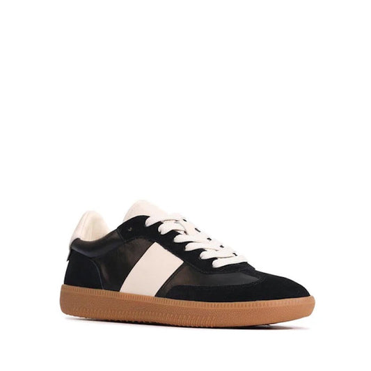 The EOS Antigo Black Leather Lace Up Trainer is a low-top sneaker featuring a white side stripe, white laces, cushioned footbed, white tongue, and vintage gum sole, displayed in a three-quarter view on a plain white background.