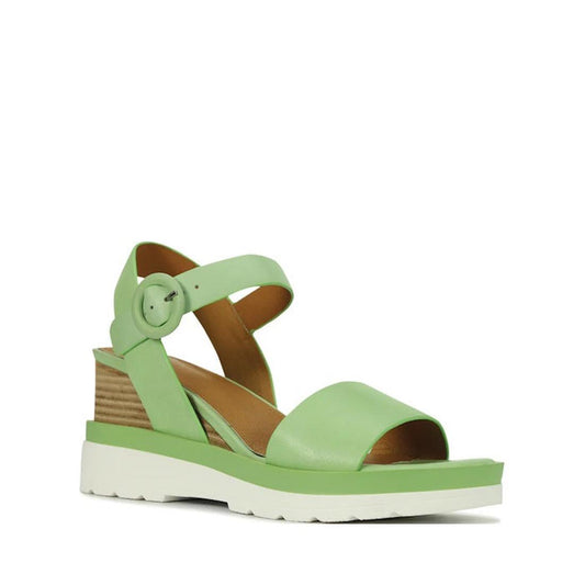 The EOS Jadon Mint Leather Wedge Sandal features a light green leather upper, open toe, large buckle ankle strap, tan lining for comfort, stacked wedge heel, and a white platform sole. Now on clearance.