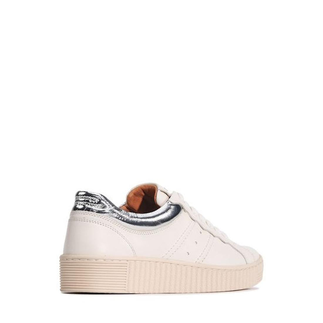 The EOS Jolie Bone Beige Women's Leather Trainer features white leather, a cream sole, metallic silver heel patch, and side zip. Shown from the rear side on a white background, these sneakers blend comfort and style for everyday wear., 47242, 932119130820