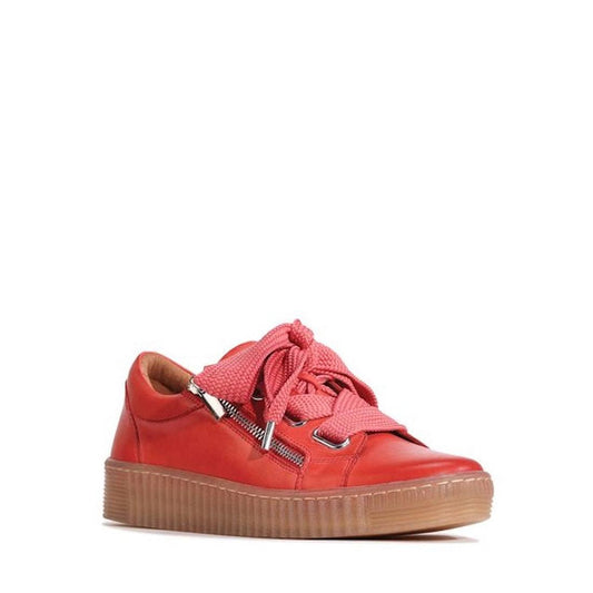 The EOS Jovi Sunset Coral Women's Leather Trainer features cashmere leather, thick laces, silver eyelets, a side zipper detail, and a textured brown rubber sole, shown against a white background.