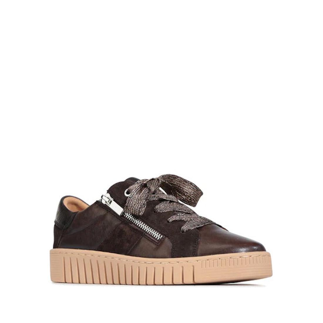 The EOS Tinah Mahogany Dark Brown Leather Trainer With Zip showcases a mixed-material upper in suede and leather, metallic laces, side silver zipper detail, and a thick tan rubber sole, displayed against a white background.