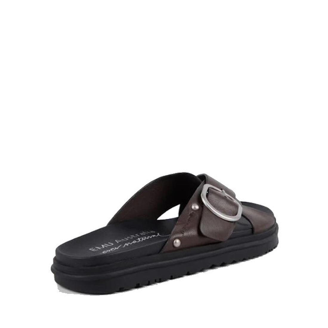 The Emu Ebony Espresso Black Leather Slide Sandal features a wide crisscross strap, adjustable buckle, and black cushioned sole, shown against a plain white background., 9330071983454, 9330071983461, 9330071983478, 9330071983485, 9330071983492, 9330071983