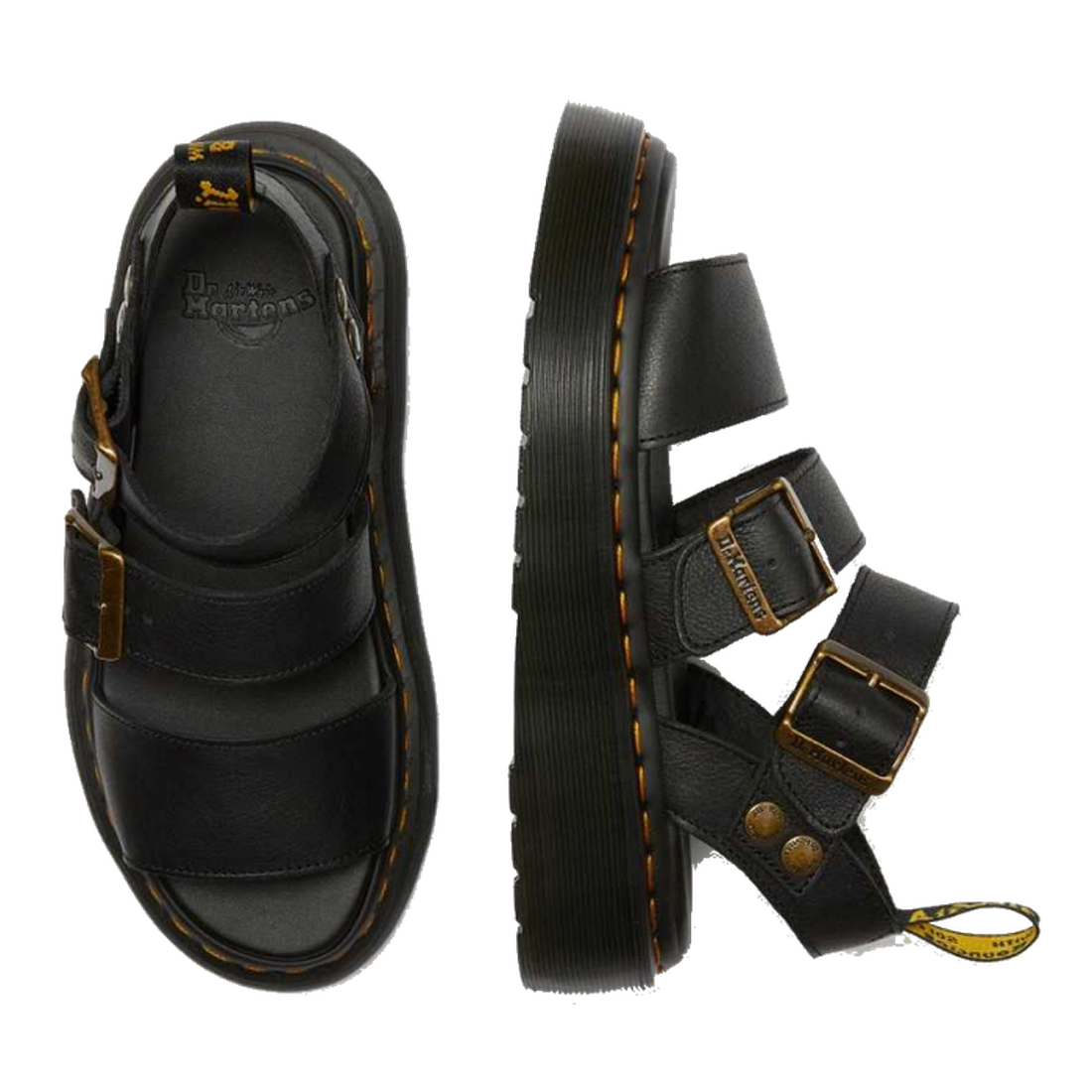 A flaylay shot of the Dr Martens Quad Gryphon Sandal in Black in Pisa Leather. A top down view of the inner sole footbed of the right foot. A side outer foot view of the left foot showing yellow stitching around the sole. 2 staps over yhe top of the foot.