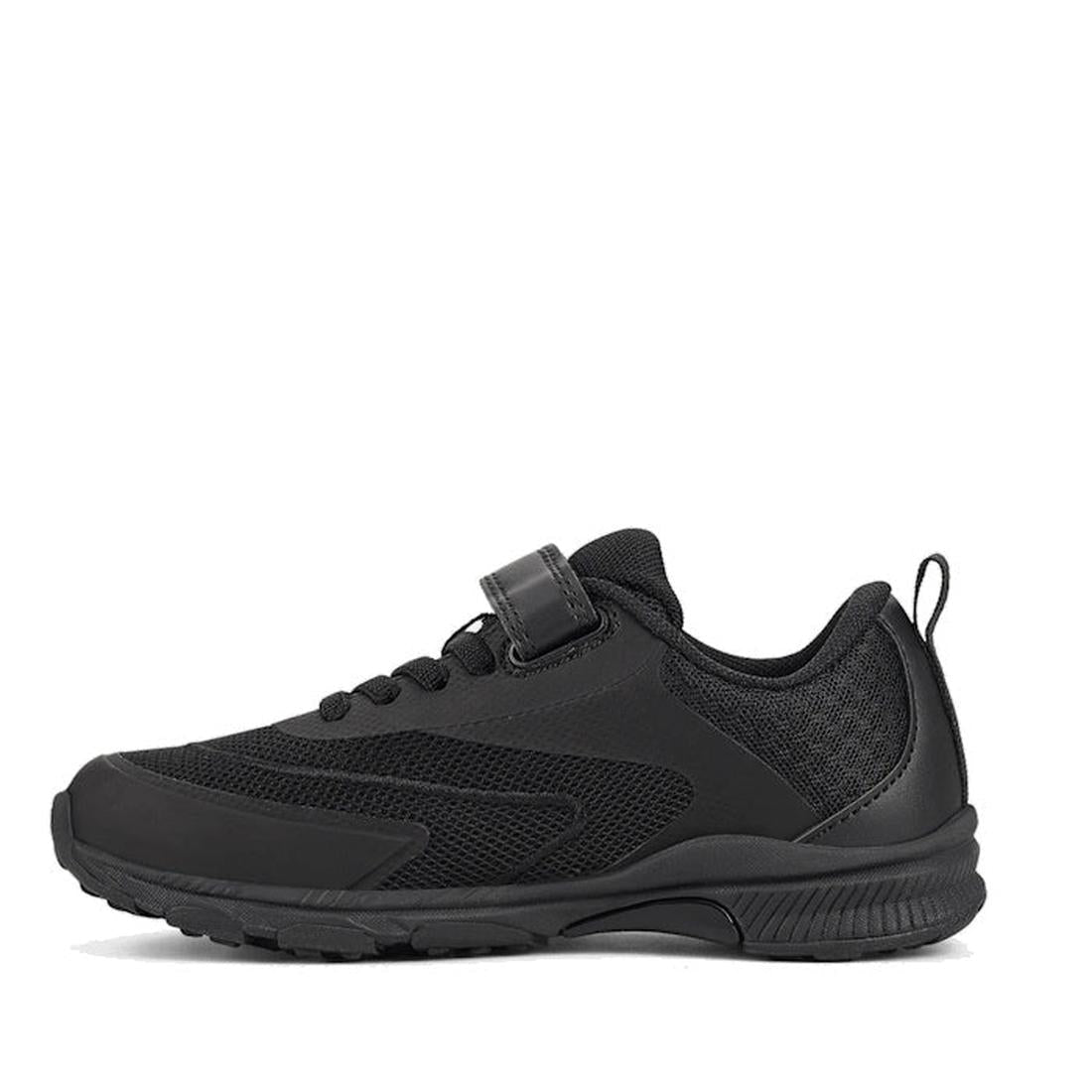 The Harrison Nifty Black School Trainer is a kids’ sports shoe with a textured sole, breathable mesh panels, lace-up front, small hook-and-loop strap, and heel pull tab, shown in side profile against a white background., 48569, 48570, 48571, 9361913034997