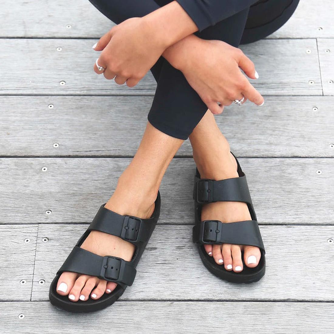 a woman sitting crosslegged showing the top down view of Holster sundreamer sandals in black. Top down view of the feet showing postion of the thickish adjustable straps over the top and top of the foot.
9337771143485,
9337771143492,
9337771143508,
933777