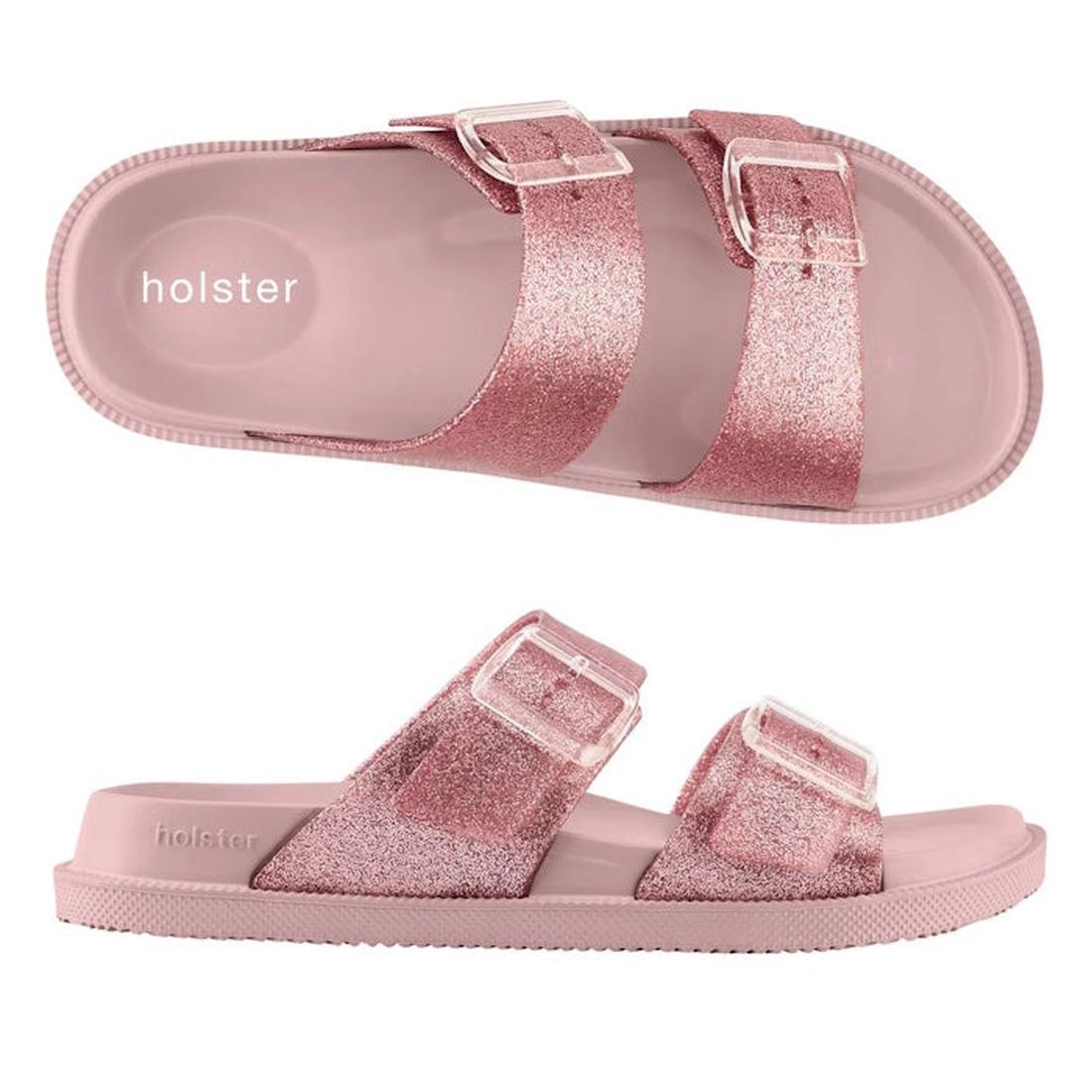 Introducing the Holster Womens Soleshimmer Pink Glitter Summer Slide – these vegan slide sandals feature two adjustable buckle straps for a personalized fit and effortless style. Designed with a flat sole and gentle arch support, they offer all-day comfor
