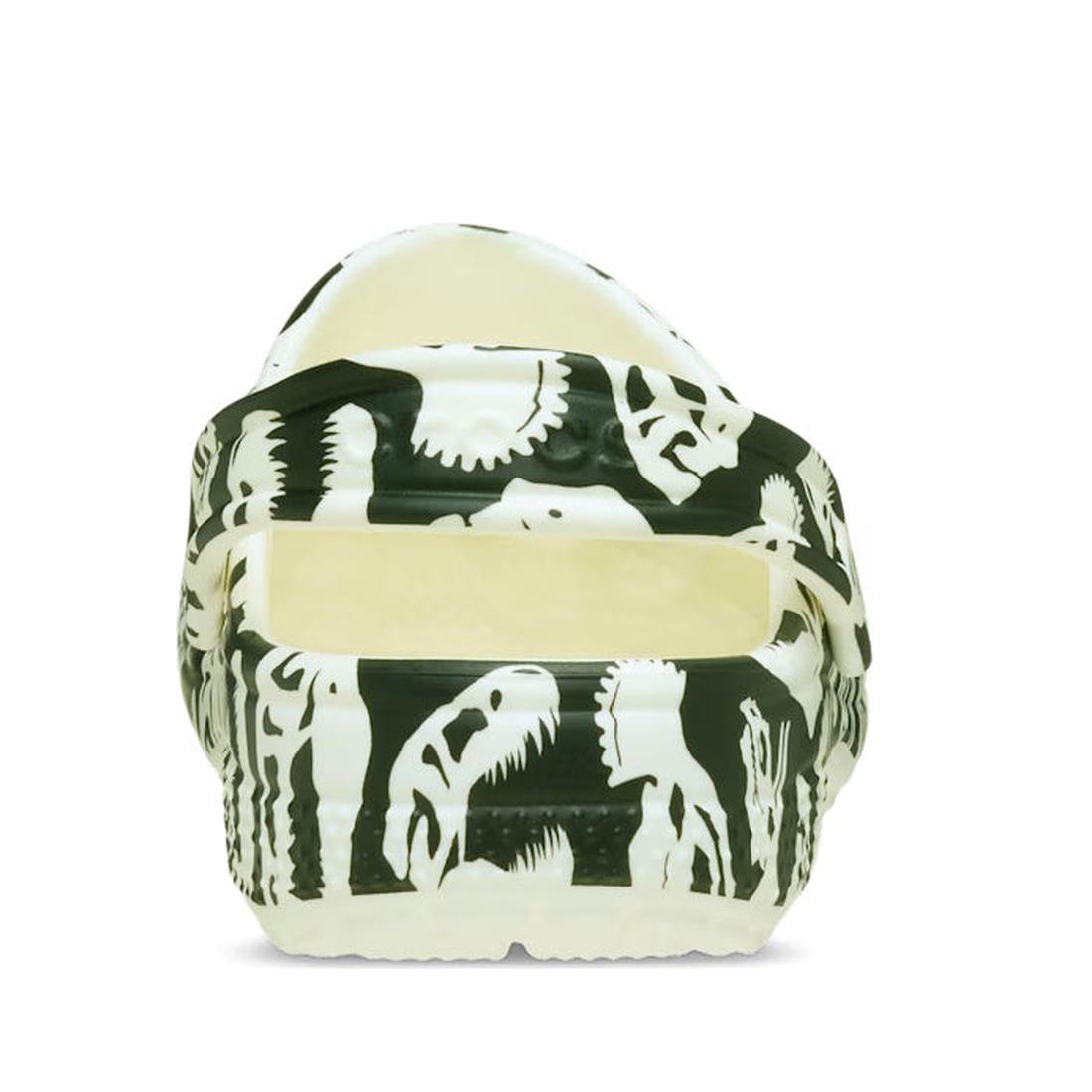 The Crocs Kids - Youths Classic Glow Dino Clog K Black Sandal is shown from the rear. These crocs-style sandals for kids feature a back strap and dino pattern, displayed against a plain white background., 198445261459, 198445261466, 198445261473, 19844526