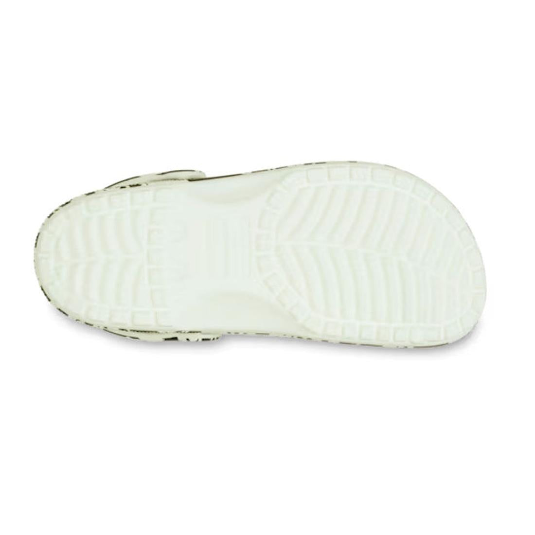 The image shows the bottom view of the Crocs Kids - Youths Classic Glow Dino Clog K Black Sandal, featuring a textured rubber sole with patterned tread for grip. This closed-toe design is ideal for kids who love fun, practical dinosaur-themed footwear., 1