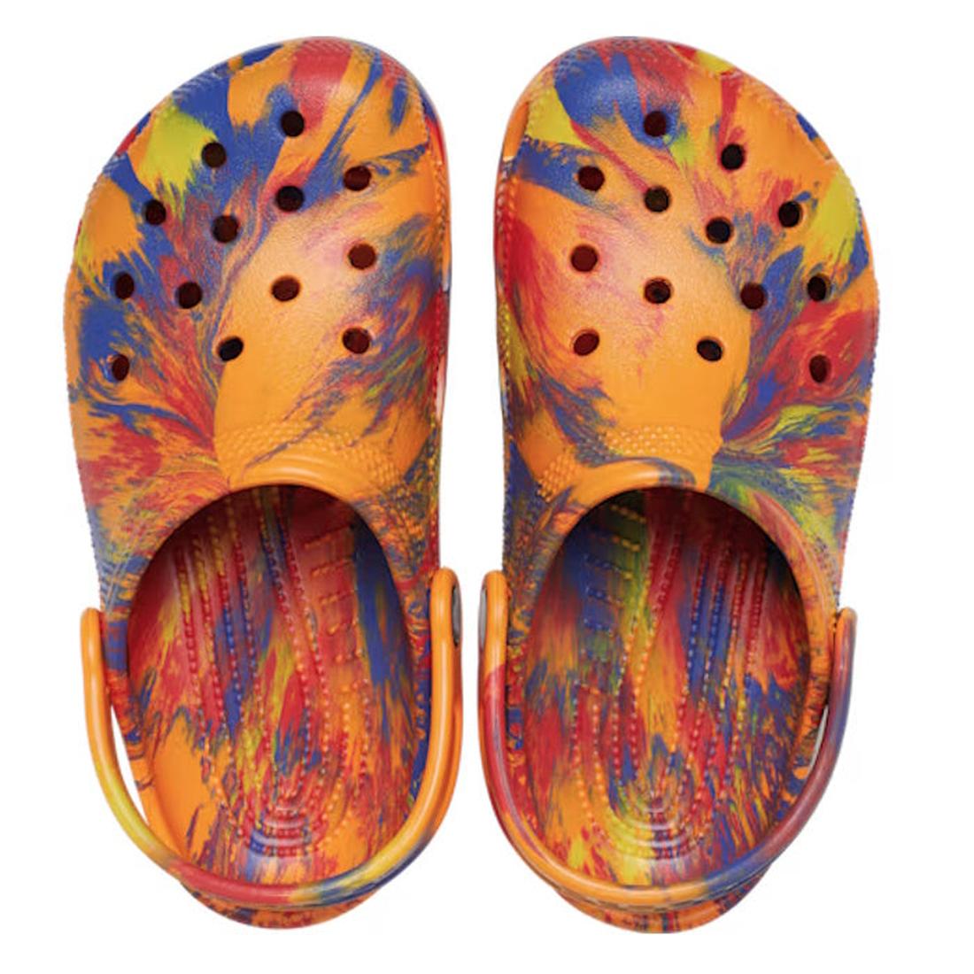 The Crocs Kids Toddlers Classic Clog K Marbled Orange Zing Multi features a swirling orange, blue, red, and yellow tie-dye pattern, ventilation holes on top, and orange heel straps. Shown from a top view., 198445269745, 198445269752, 198445269769, 1984452, 198445269776, 198445269714