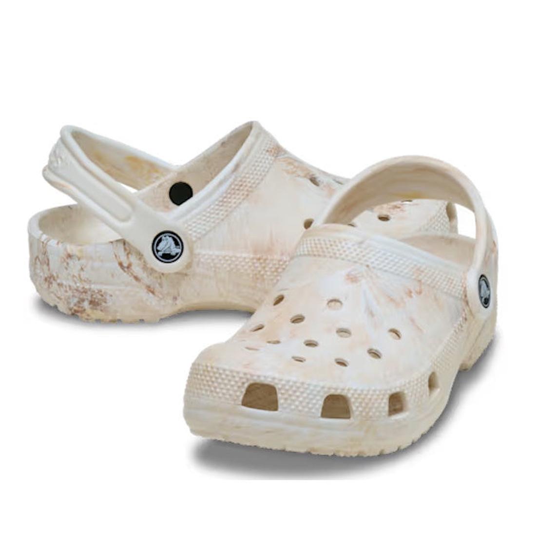 A pair of Crocs Kids - Watercoloured Marbled Clog Sandal Bone Swirl Youths with ventilation holes, adjustable heel straps, and Croslite foam for comfort, displayed against a white background.