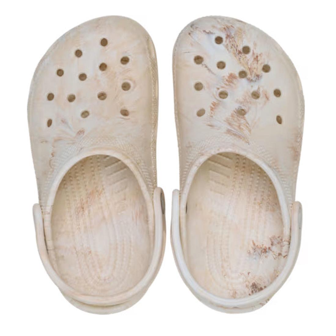 A pair of Crocs Kids - Watercoloured Marbled Clog Sandal Bone Swirl Youths with ventilation holes and a bone swirl marbled pattern, made from lightweight Croslite foam for comfort, viewed from above on a white background., 198445279461, 198445279478, 1984