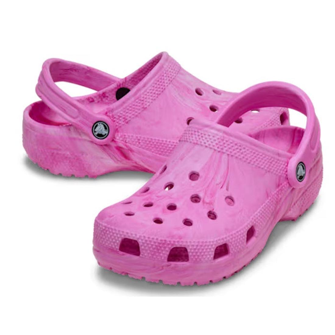 A pair of Crocs Kids - Watercoloured Marbled Clog Sandal Pink Swirl Youths, featuring bright pink marbled design, ventilation holes, adjustable heel straps, and lightweight Croslite foam, displayed on a white background.