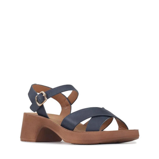 The Los Cabos Alegra Navy Wedge Platform Backstrap Sandal features minimalist crisscross straps, an ankle buckle, a low brown block heel, and a cloud-soft outsole, shown on a white background.