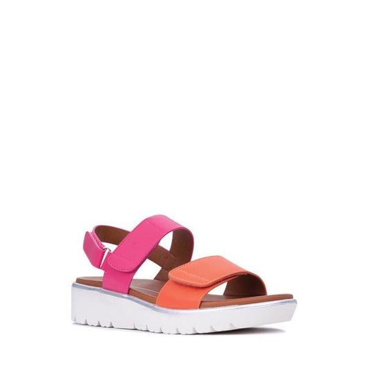 The Los Cabos Arica Orange Fuchsia Summer Women's Sandal features a thick white platform sole, pink and orange crisscross vegan leather straps, and an adjustable back strap, displayed on a plain white background.