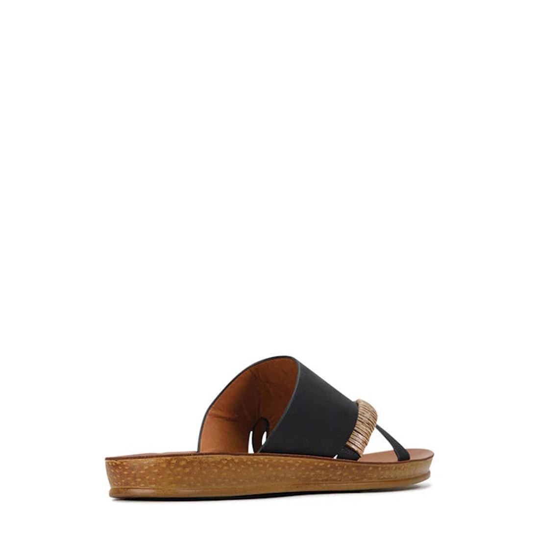 The Los Cabos Bride Black Flat Slide Sandal features a cork sole, black wide cross strap, and a tan braided accent strap—perfect for resort wear. Displayed on a white background., 9321191054629, 9321191054636, 9321191054643, 9321191054650, 9321191054667, 