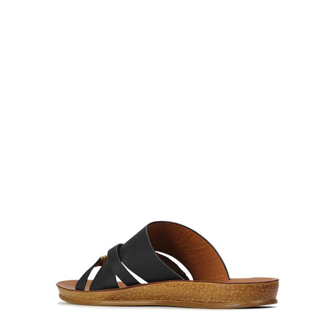 The Los Cabos Bride Black Flat Slide Sandal features a crisscross strap design and a tan textured flat sole, making it perfect for resort wear. Displayed against a plain white background., 9321191054629, 9321191054636, 9321191054643, 9321191054650, 932119