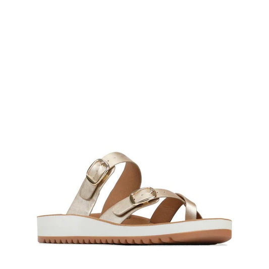 The Los Cabos Nins Champagne Adjustable Women's Summer Sandal features two metallic buckled straps, a white platform sole with a brown textured bottom for subtle arch support. Shown in side view against a plain white background.