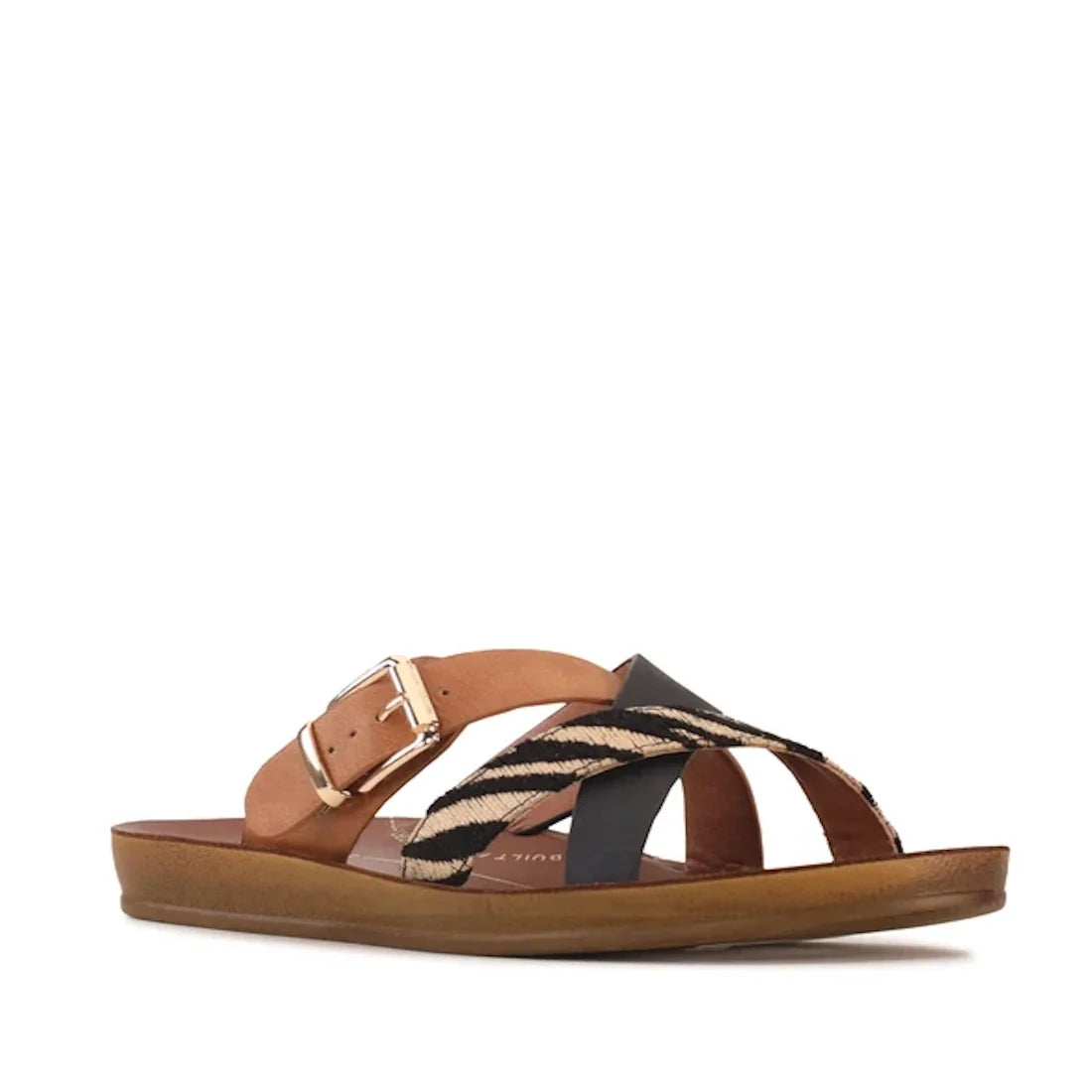 The Los Cabos Brik Black Brandy Zebra Women’s Slide Sandal features a tan sole with black and brandy criss-cross straps, braided detailing, and a gold buckle accent. Designed with an anatomical footbed for all-day comfort, these sustainable sandals seamle