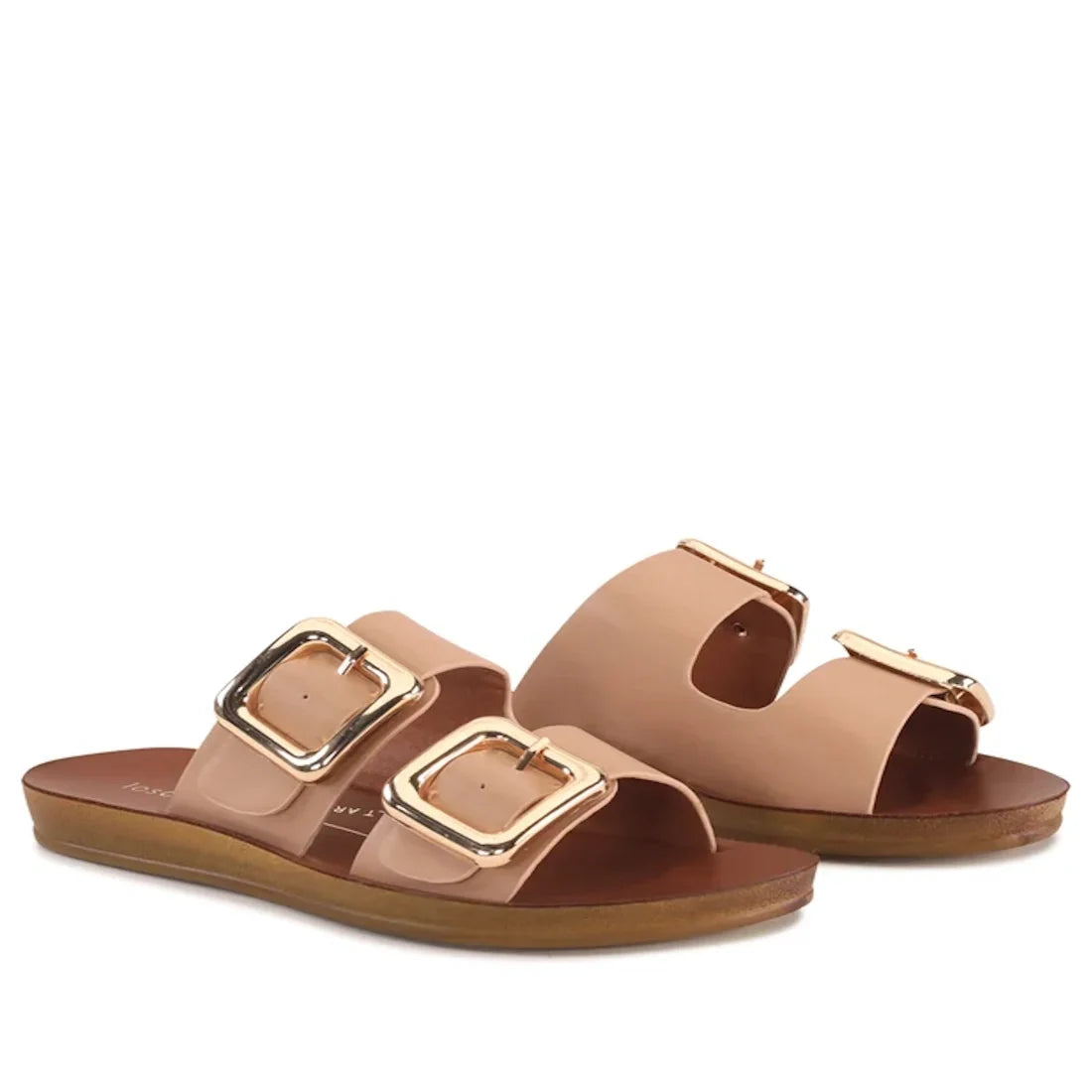 Introducing the Los Cabos Womens Dina Pecan Beige Light Flexible Two Strap Slide Sandal, featuring a pair of nude-colored slides with two wide straps adorned with large gold buckles and flat brown soles, thoughtfully designed with an anatomical footbed fo