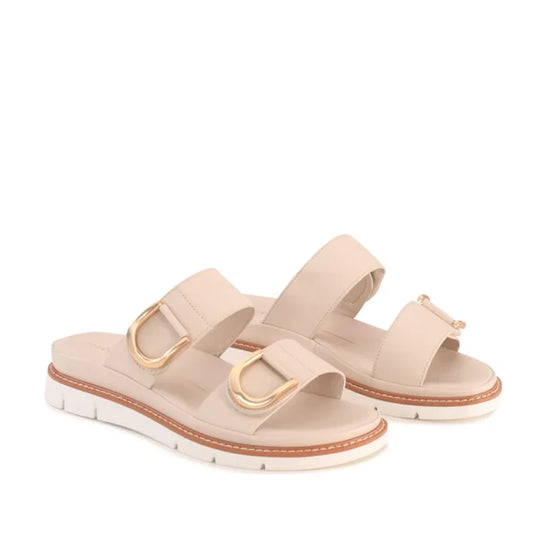 The Los Cabos San Women’s Slide Double Strap Sandal in Bone features two wide straps with gold buckle accents and white platform soles with brown trim. These minimalist slide sandals offer the perfect blend of comfort and style for summer, shown here agai