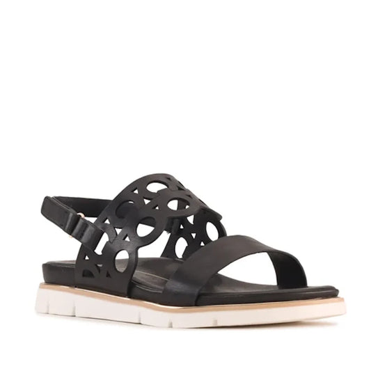 The Los Cabos Terica Black Sandal With Back Strap features an open toe, distinctive cutout circular patterns on the upper strap, a secure ankle strap, and a thick white sole—perfect for anyone seeking comfortable sandals.