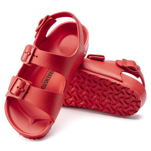 Birkenstocks Kids Active Red Milano EVA Sandal (Narrow Width): bright red, waterproof sandals with two adjustable buckle straps and textured, wavy soles. One sandal stands upright; the other is on its side showing the sole pattern.
